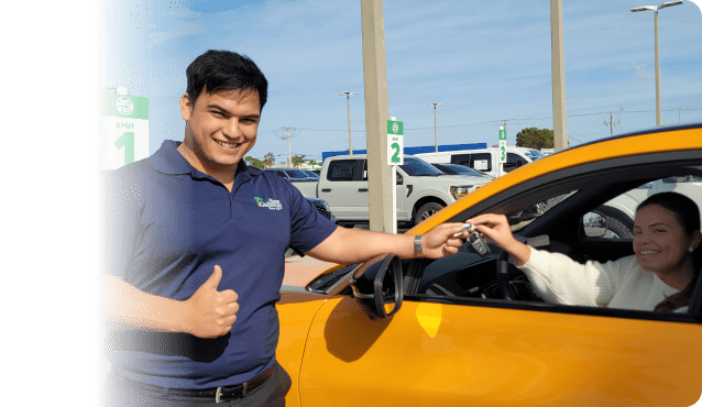 Woman receiving keys to a Test Drive To Go vehicle