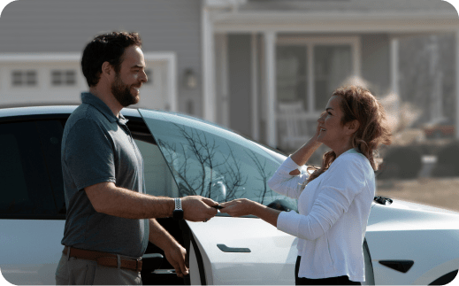 Woman receiving keys to a Test Drive To Go vehicle